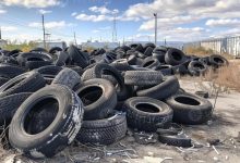 ai generated old tires dumped in landfill a pile of old tires at an industrial site photo x